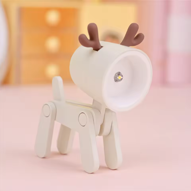 White deer-shaped night light with brown antlers on a pink background