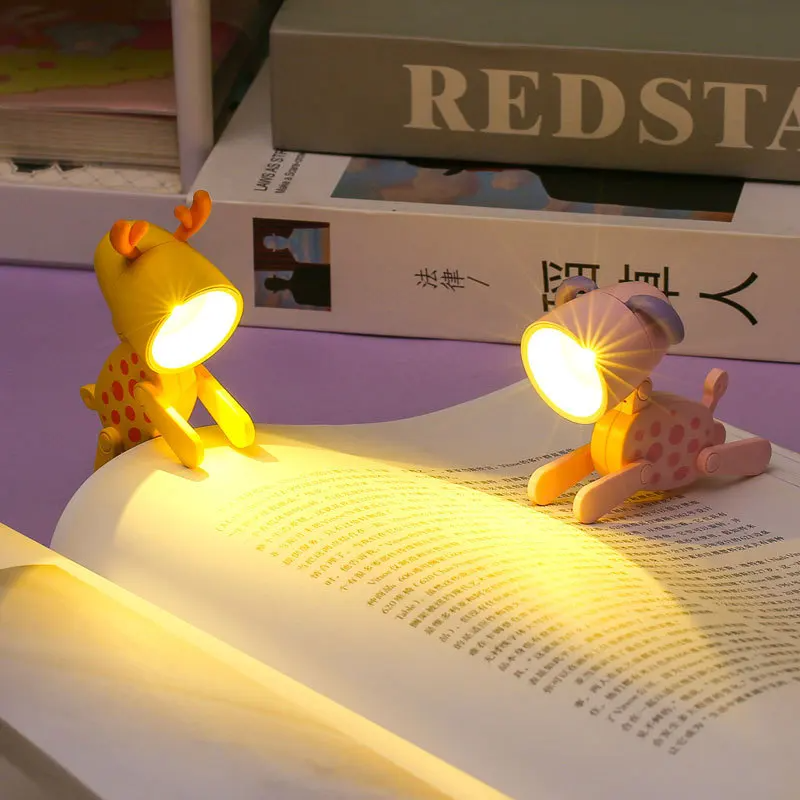 Two animal-shaped night lights on an open book with a blurred background.