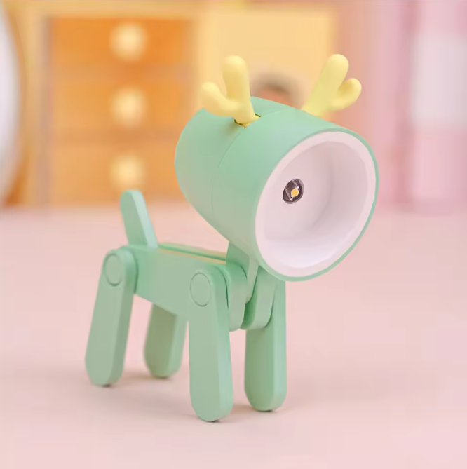 Green reindeer-shaped night light on a soft pink background