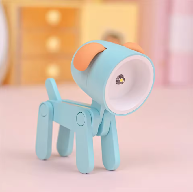 Toy dog with a blue body and orange nose on a pink background