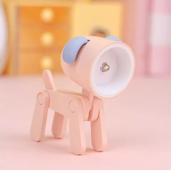 Pink dog-shaped lamp with a blue ear on a pink background