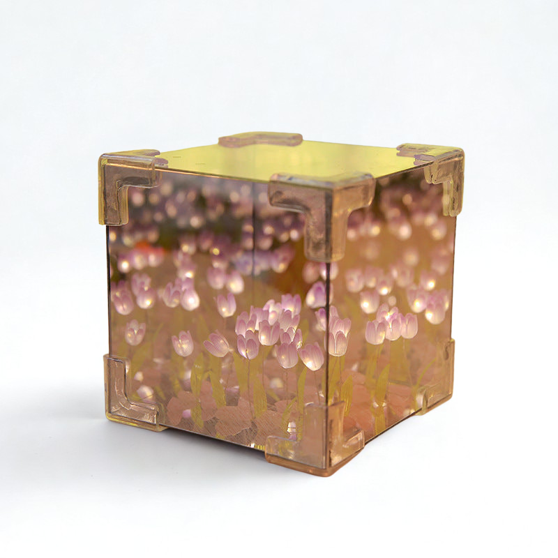 Transparent cube with pink and purple floral design on a white background