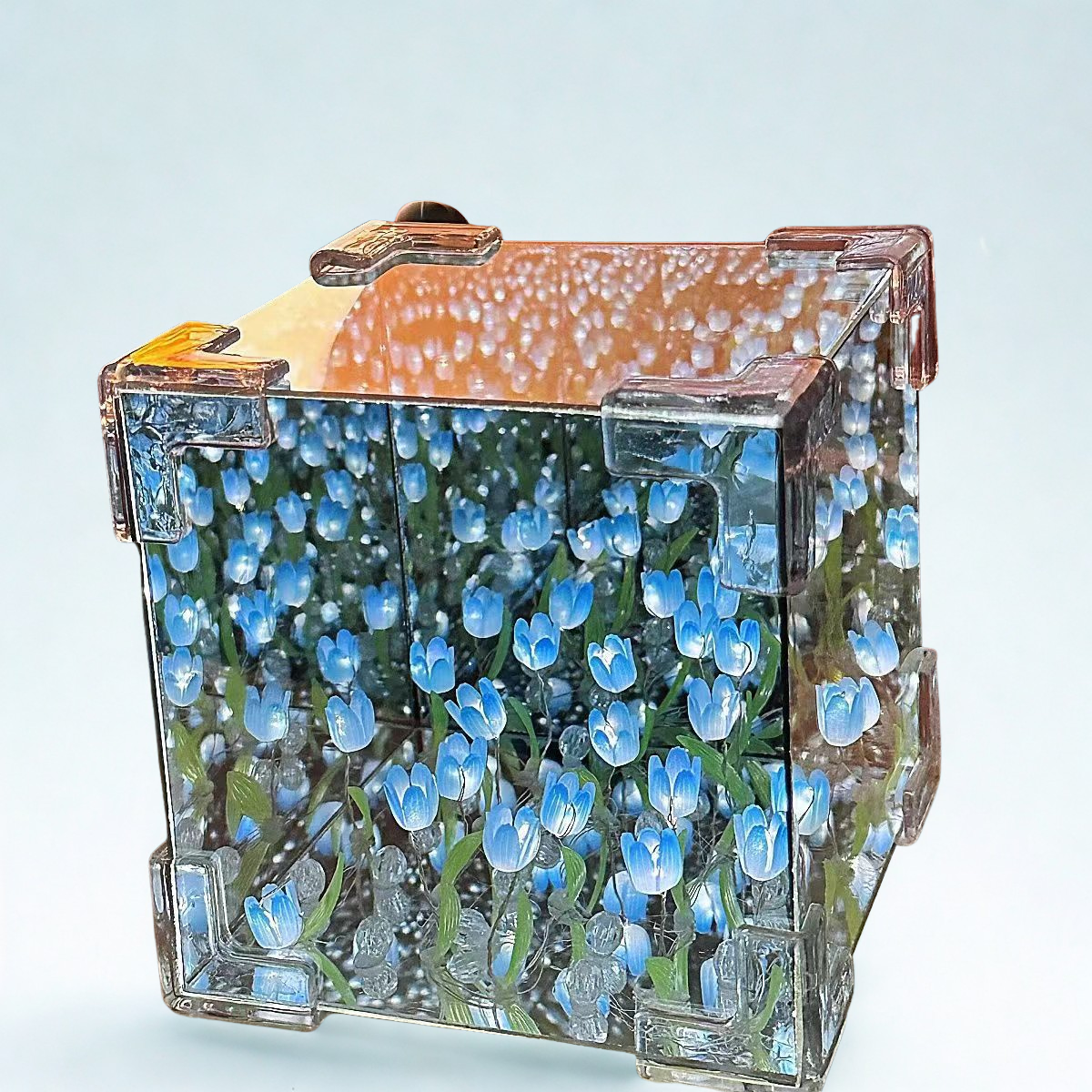 Transparent jewelry box with blue floral design on a light blue background