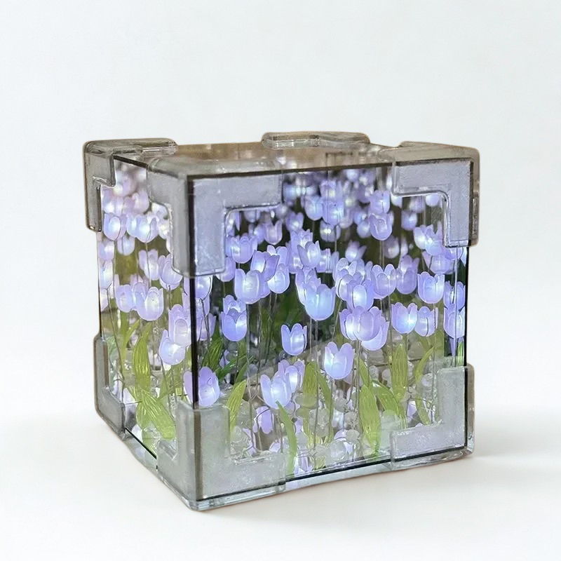 Clear cube with purple tulip flowers on a white background
