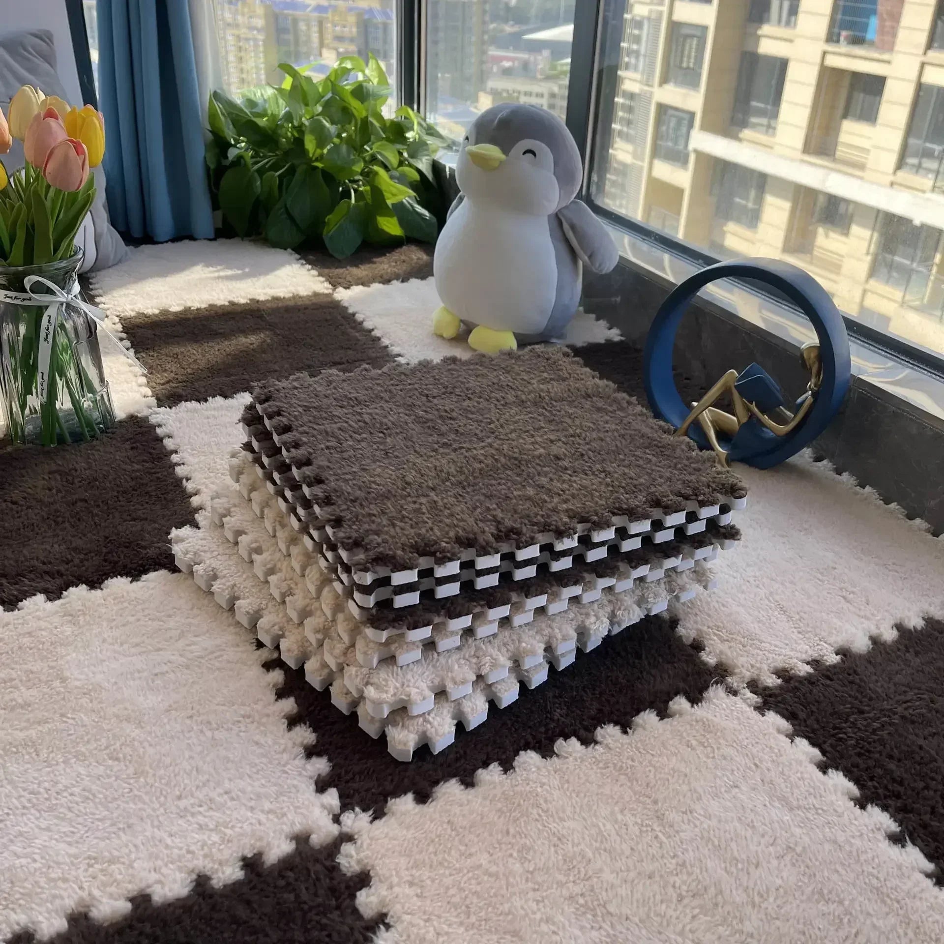 Checkerboard patterned fluffy carpet puzzle tiles displayed on a floor with a stuffed toy and decorative items in the background.
