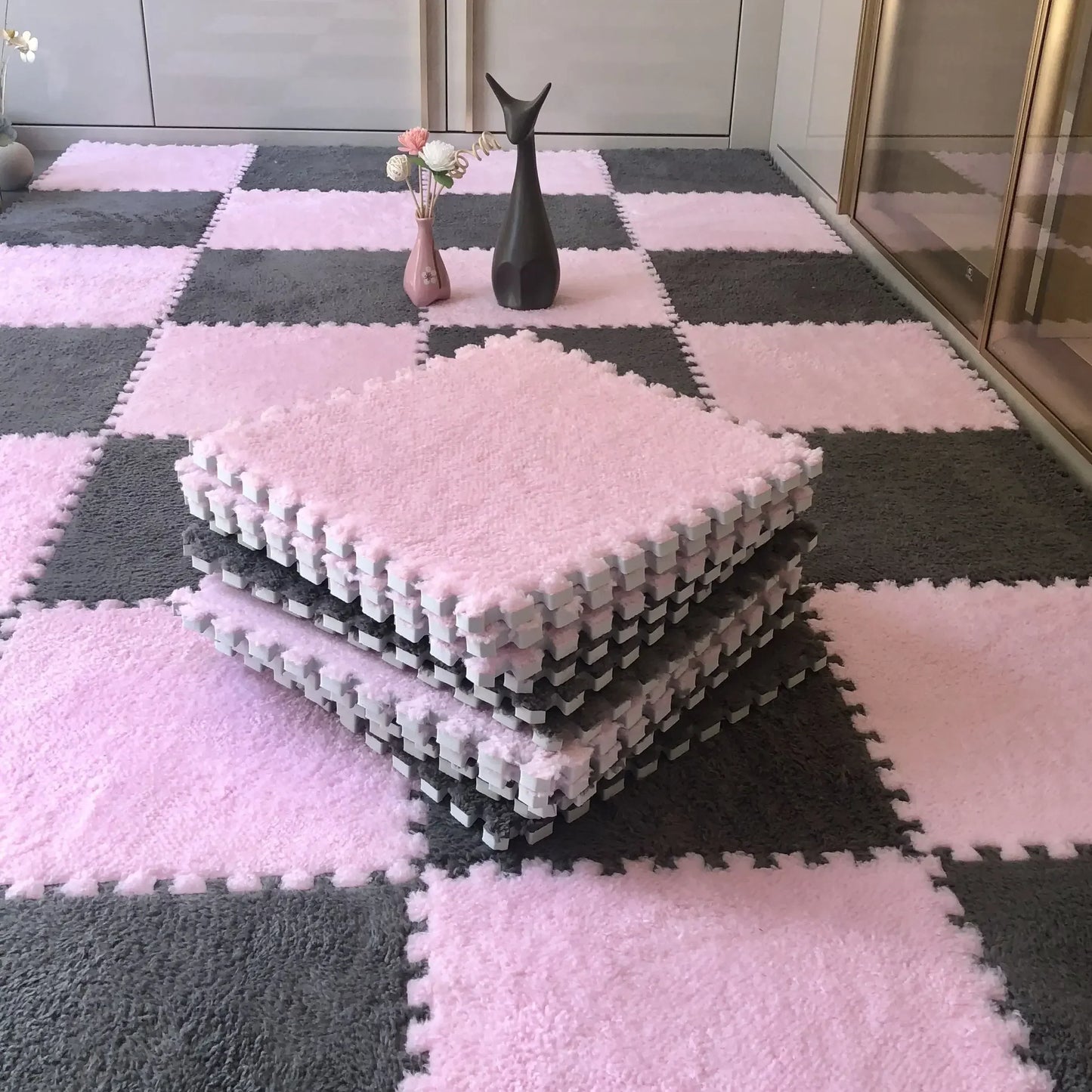 Checkerboard patterned fluffy carpet puzzle tiles displayed on a floor with a stuffed toy and decorative items in the background.