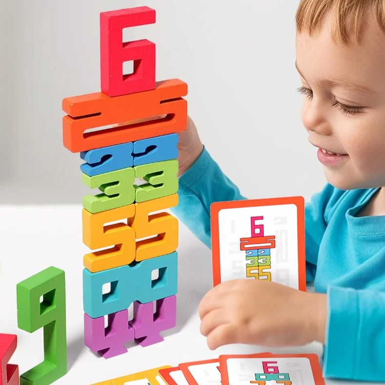 A child playing with colorful wooden number blocks stacked together to form a tower, with a card showing a number pattern.
