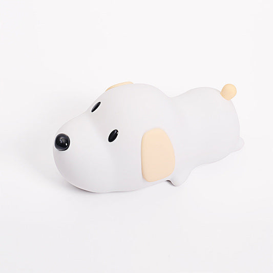 A cute puppy-shaped nightlight with a white and beige design, featuring a rounded body, small ears, and a black nose.