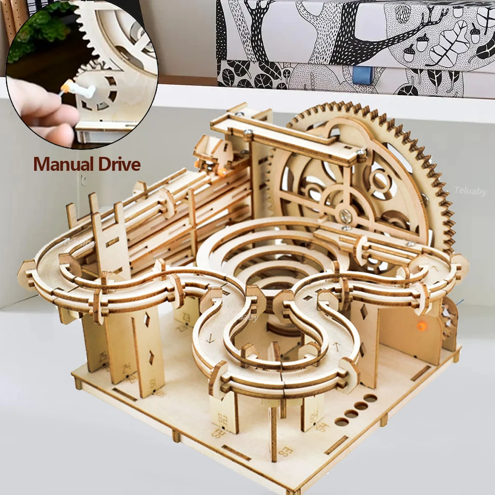 Wooden mechanical model with manual drive feature on a white background.